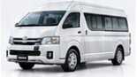 Toyota Hiace Commuter putih tampak dari sisi depan dan samping