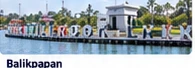 Illustration of a Balikpapan sign and a tree-lined waterfront