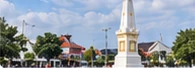 Illustration of a white monument at a road junction under a blue sky in Yogyakarta